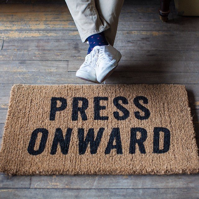 Press Onward Doormat by Izola