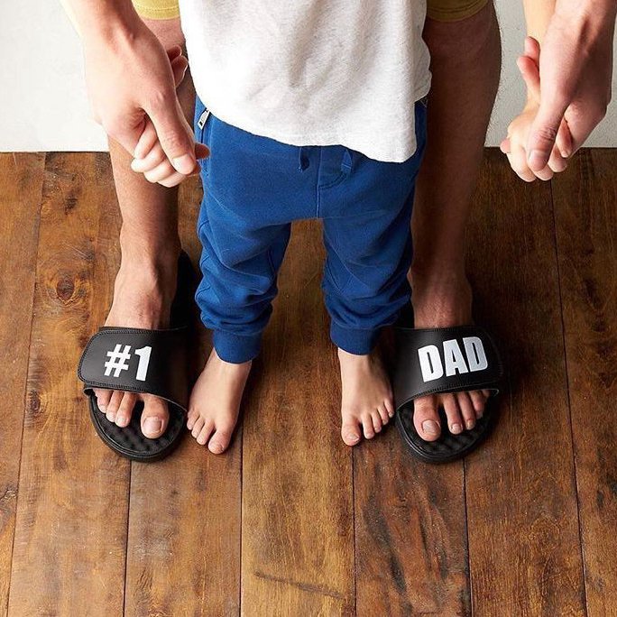 #1 Dad White Text on Black Slide Sandals