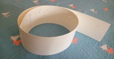 Music strip for 30 note music box using punched paper strips