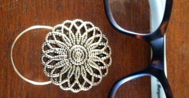 The mattie gold tone flower magnetic eyeglass holder is a