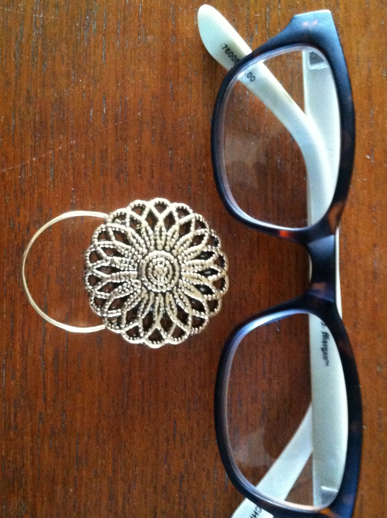 The mattie gold tone flower magnetic eyeglass holder is a