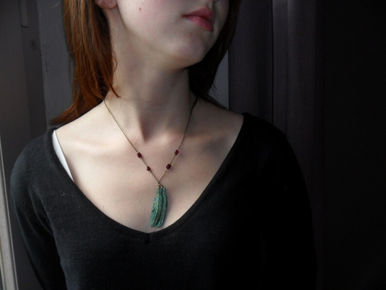 Green feather grey and garnets pendant
